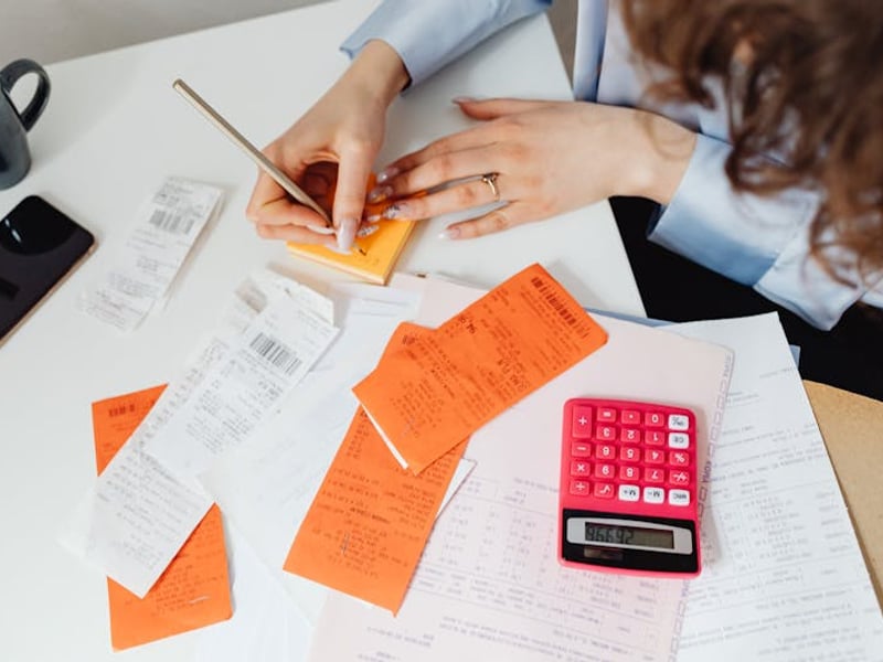 Clean workspace with laptop showing business proposal cost calculations