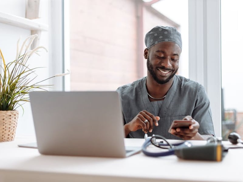 Professional sending follow-up email for business proposal using laptop